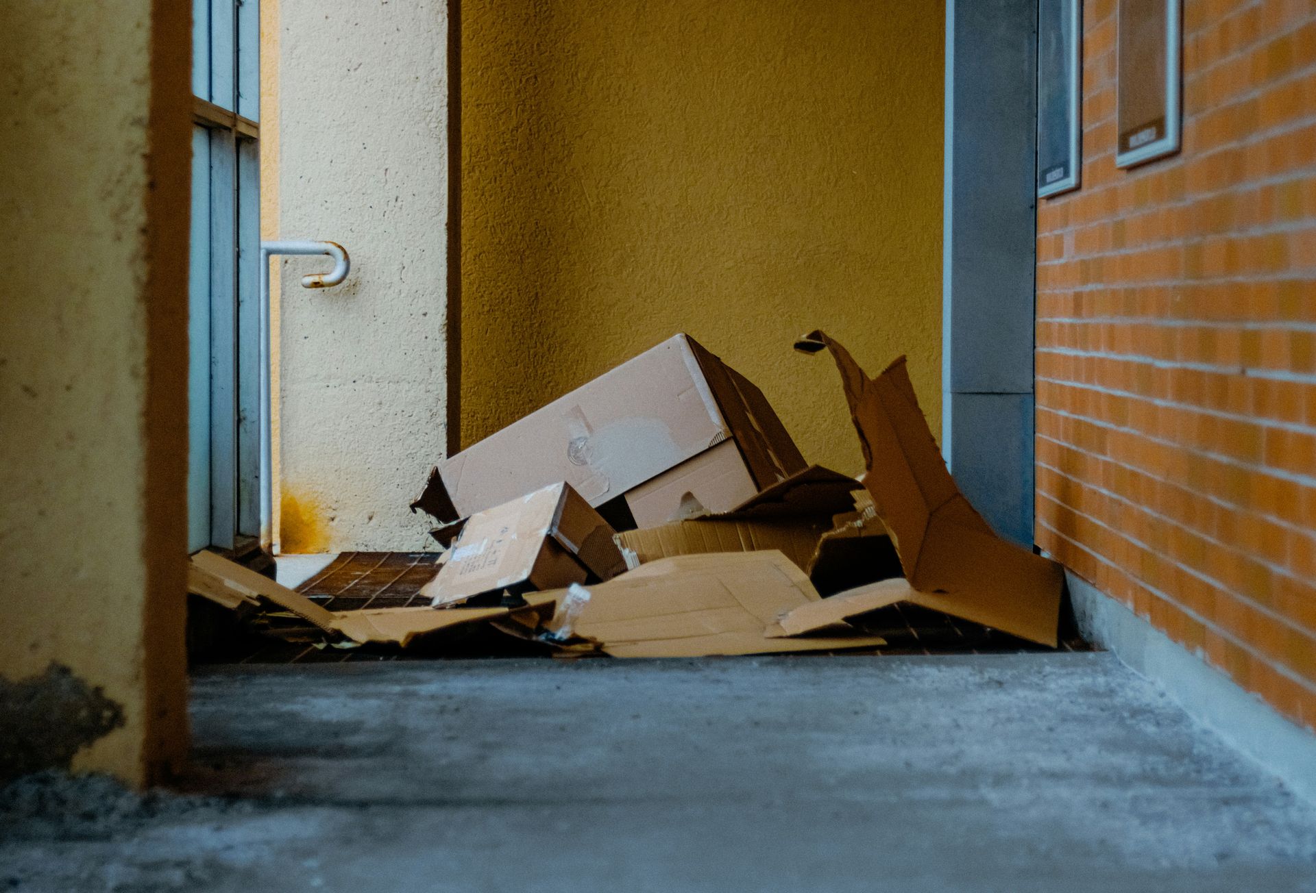 Cardboard boxes piled up outside a building entrance